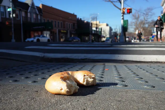 A photo of a bagel on the street